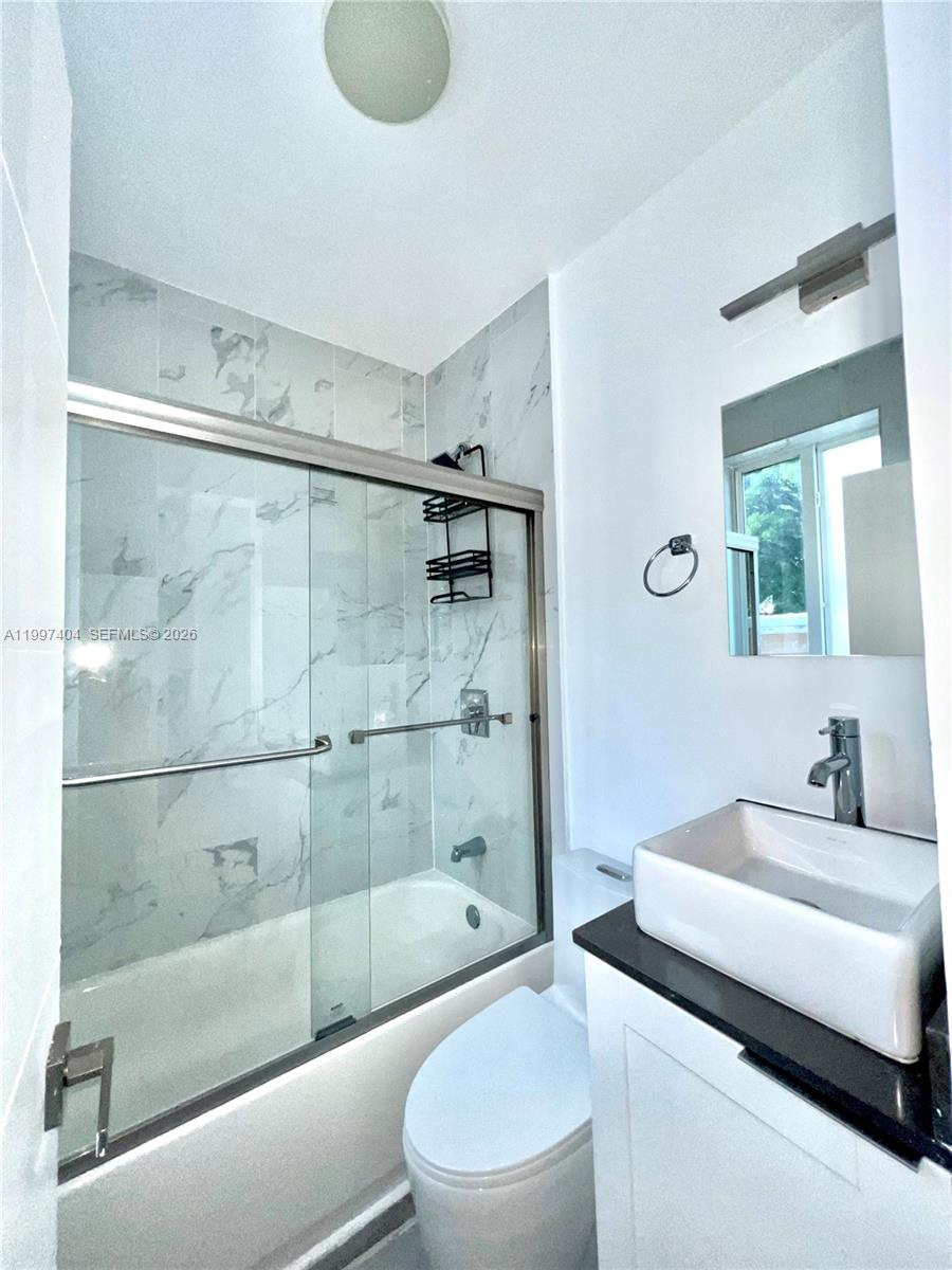 1036 Southwest 5th Street, Unit 12 Miami, FL 33130 - Photo 15 of 19 a bathroom with a sink toilet and shower