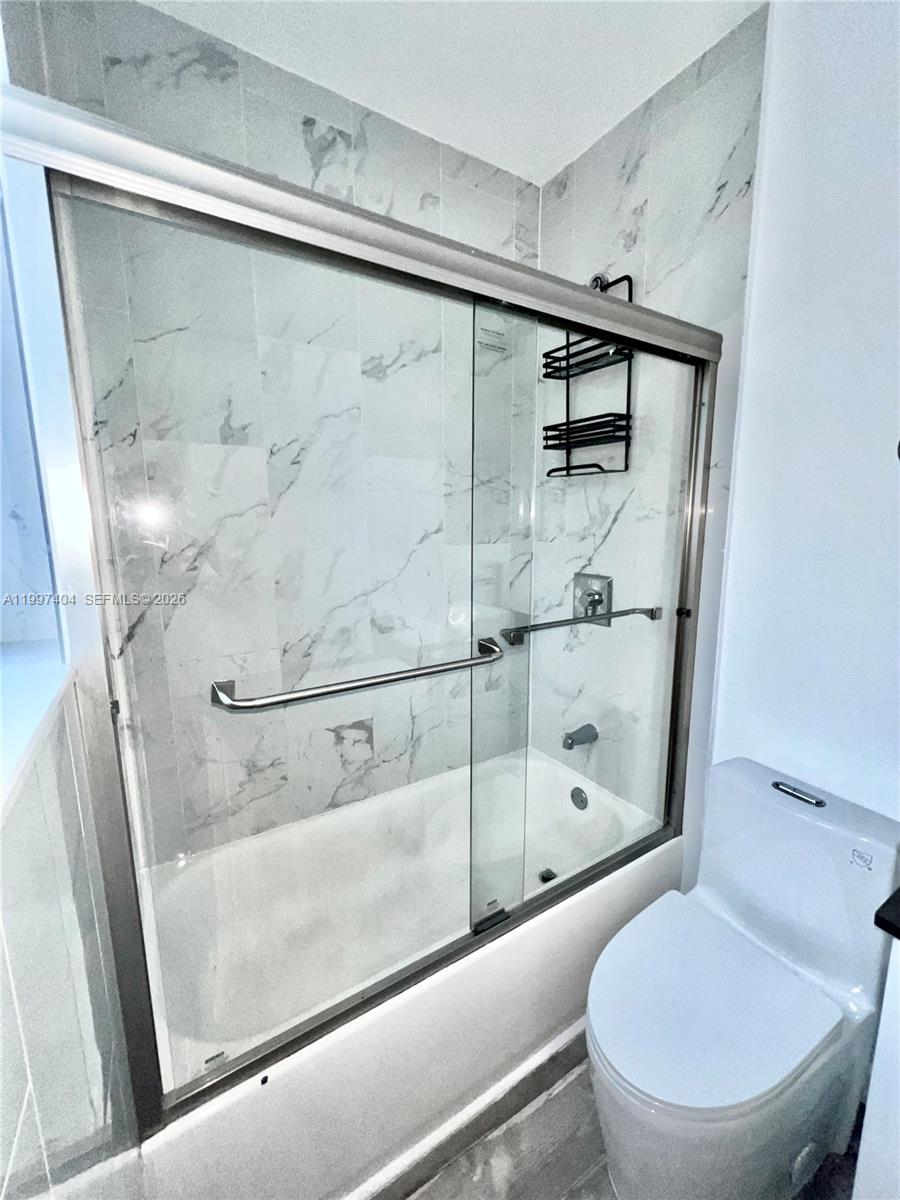1036 Southwest 5th Street, Unit 12 Miami, FL 33130 - Photo 16 of 19 a bathroom with a shower and toilet