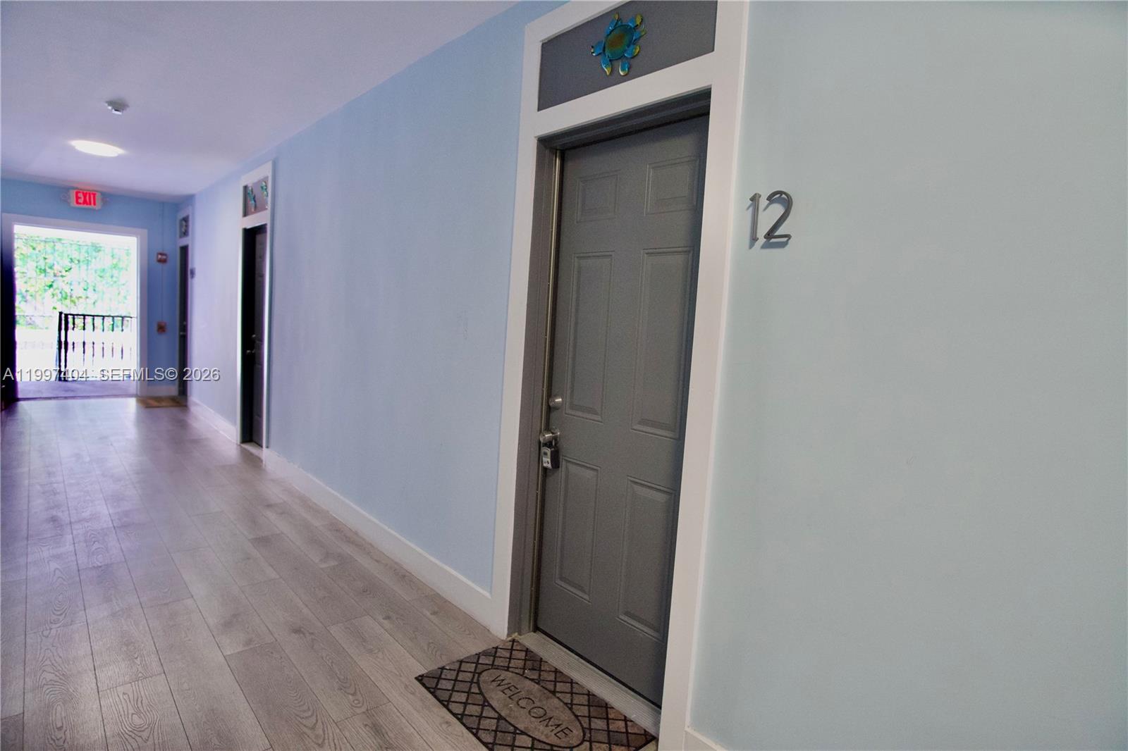 1036 Southwest 5th Street, Unit 12 Miami, FL 33130 - Photo 19 of 19 a view of a hallway with wooden floor and a livingroom