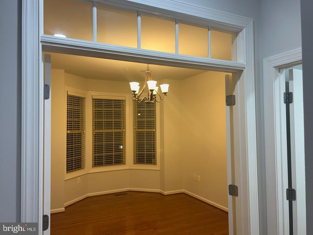 1101 Verbena Court Silver Spring, MD 20906 - Photo 12 of 36 a view of a hallway with wooden floor and a window