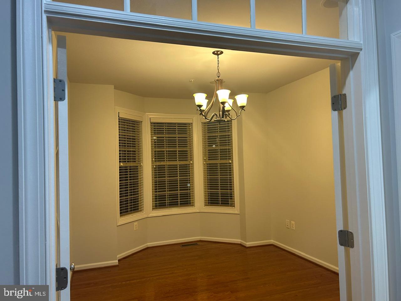 1101 Verbena Court Silver Spring, MD 20906 - Photo 14 of 36 a view of an empty room with a window and wooden floor