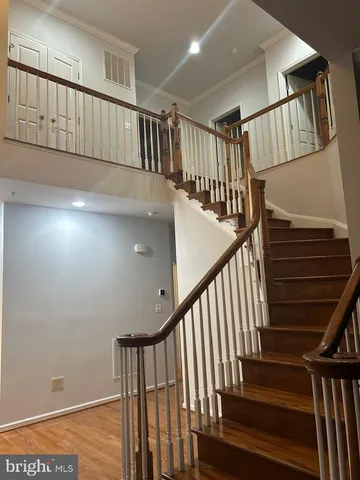 a view of staircase with railing and white walls