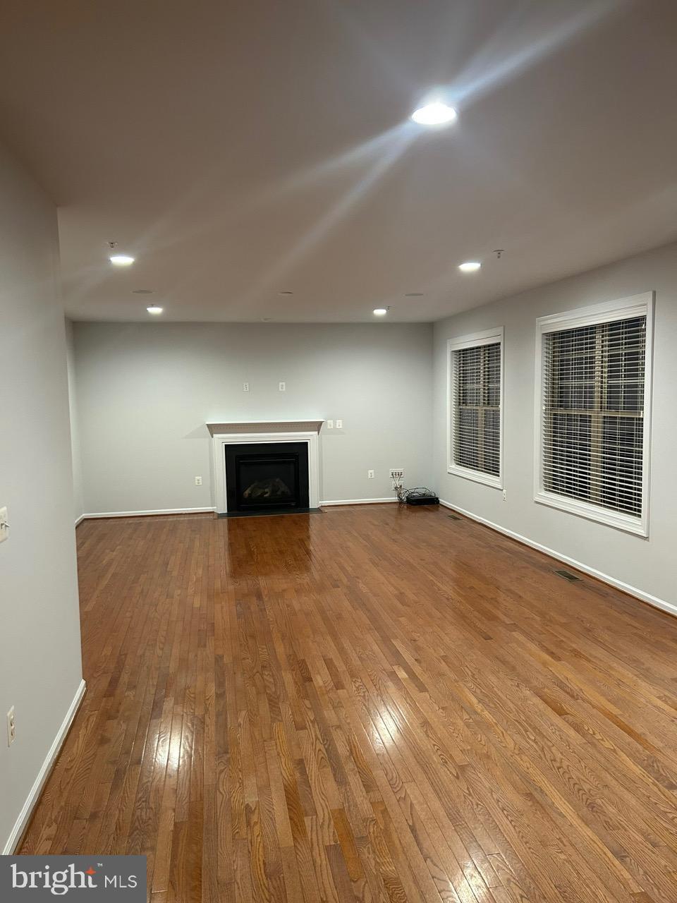 1101 Verbena Court Silver Spring, MD 20906 - Photo 2 of 36 an empty room with wooden floor and windows
