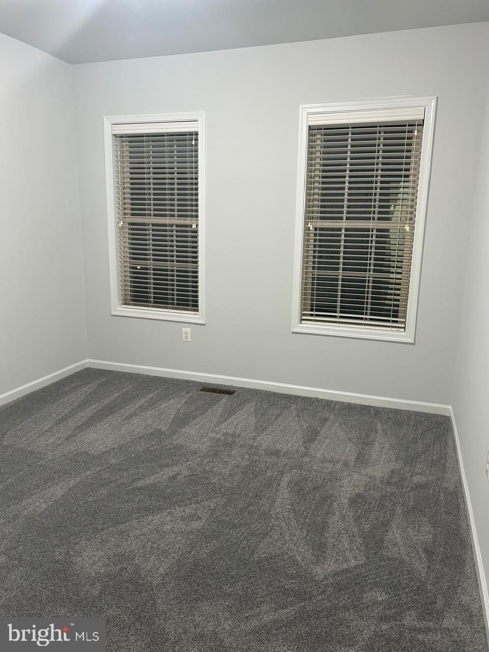 1101 Verbena Court Silver Spring, MD 20906 - Photo 28 of 36 an empty room with wooden floor and windows