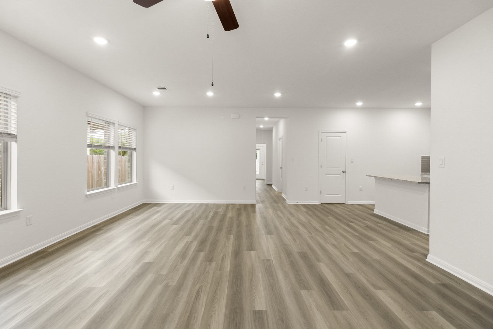 18605 Emu Lane Manor, TX 78653 - Photo 6 of 27 Spacious interior with light-toned hardwood style flooring, recessed lighting, and a ceiling fan