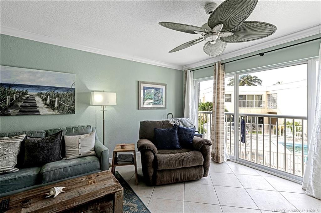 3541 Northeast Ocean Boulevard, Unit 14 Stuart, FL 34996 - Photo 5 of 15 a living room with furniture and a large window