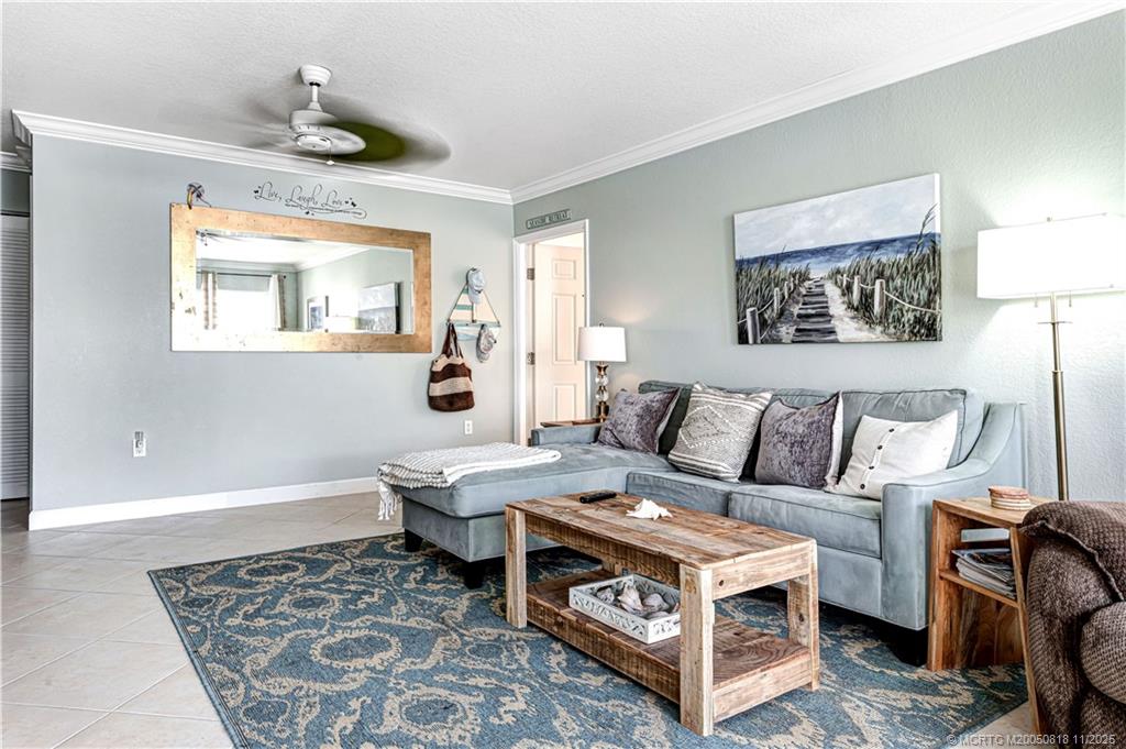 3541 Northeast Ocean Boulevard, Unit 14 Stuart, FL 34996 - Photo 7 of 15 a living room with furniture and a window