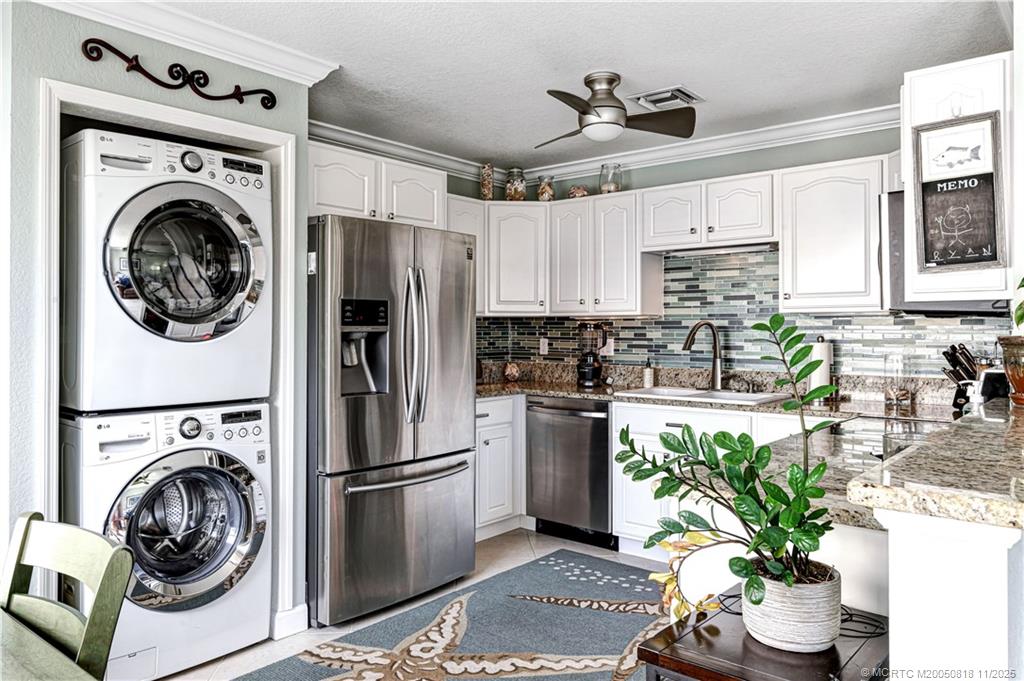 3541 Northeast Ocean Boulevard, Unit 14 Stuart, FL 34996 - Photo 9 of 15 a view of a kitchen with washer and dryer