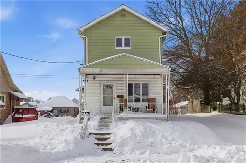 a front view of a house with yard and seating space
