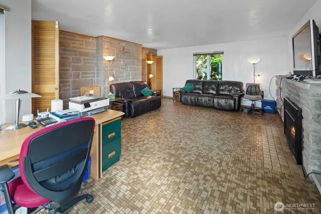 a living room with furniture a flat screen tv and a fireplace