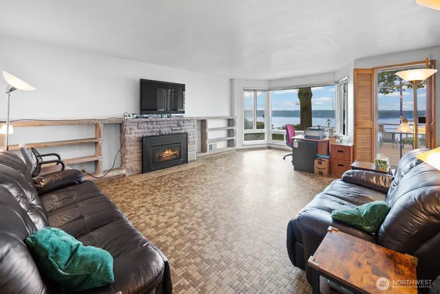 a living room with furniture fireplace and flat screen tv