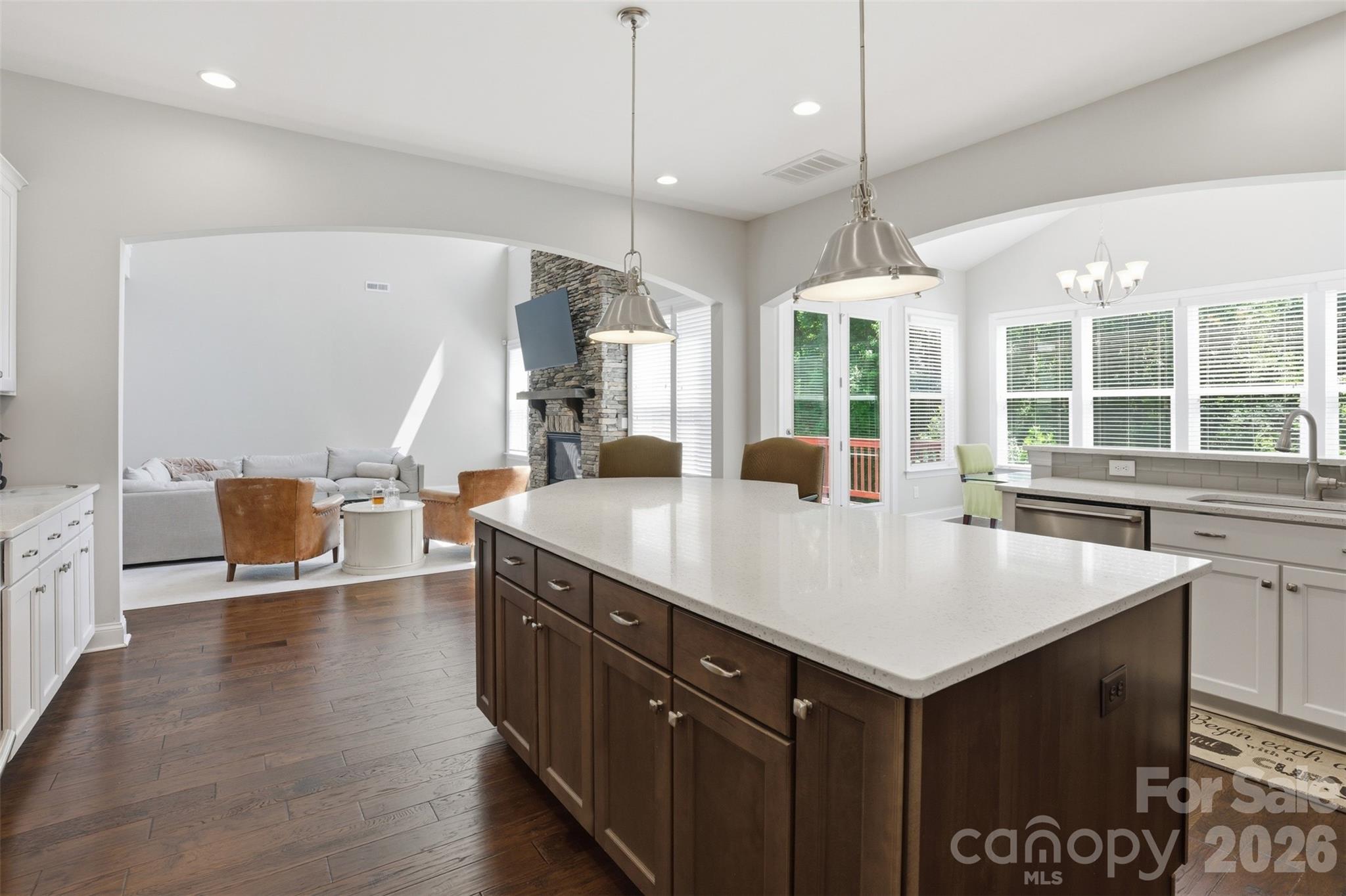 14022 Salem Ridge Road Huntersville, NC 28078 - Photo 12 of 38 a large kitchen with kitchen island a sink a counter space and a living room view
