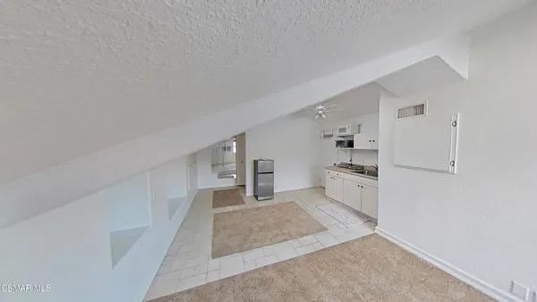 a large white kitchen with cabinets