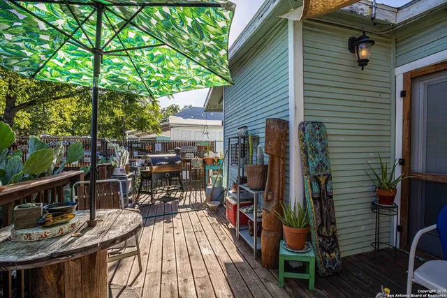 a view of balcony and deck with wooden floor and outdoor seating