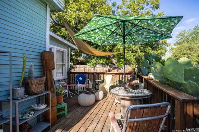 a view of a balcony with chairs and potted plants