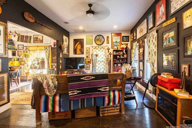 a living room with furniture flat screen tv and wooden floor