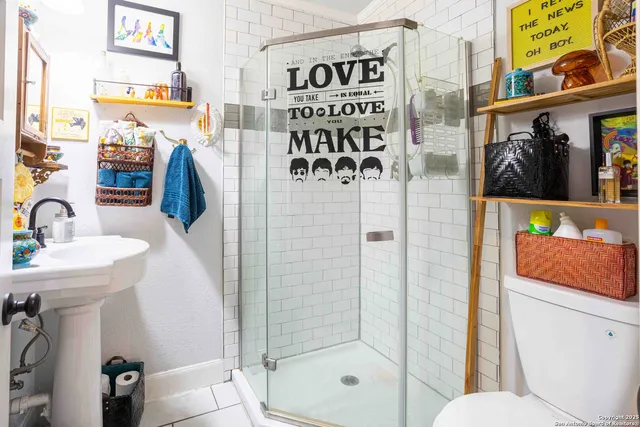 a bathroom with a sink toilet and shower