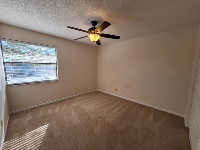 a view of empty room with ceiling fan