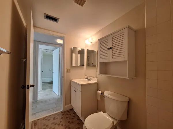 a bathroom with a toilet sink shower and mirror