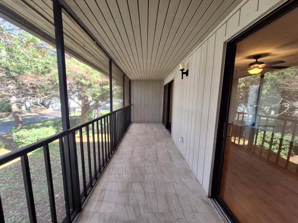 a view of a room with wooden floor and stairs