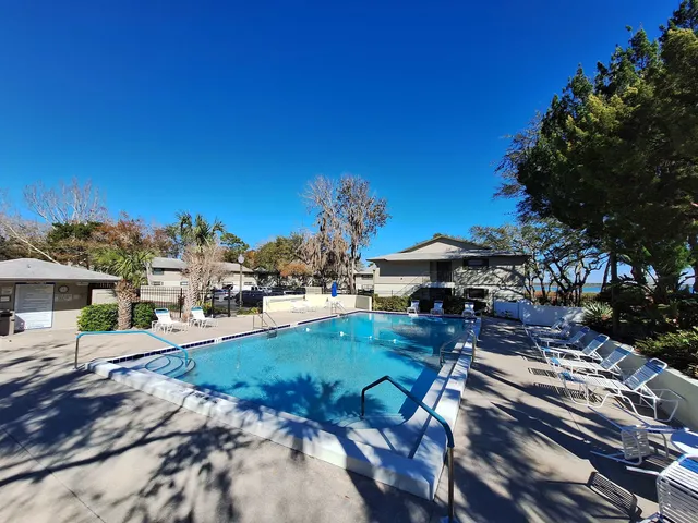 a view of a backyard with sitting area