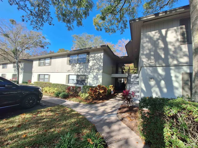 a view of backyard of house with green space