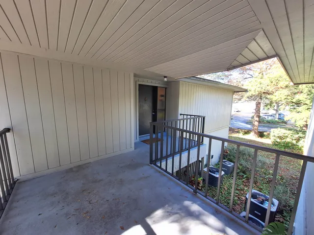 a view of balcony with wooden floor