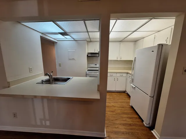 a kitchen with kitchen island a counter top space and refrigerator