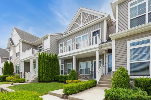 a front view of a house with a yard and plants