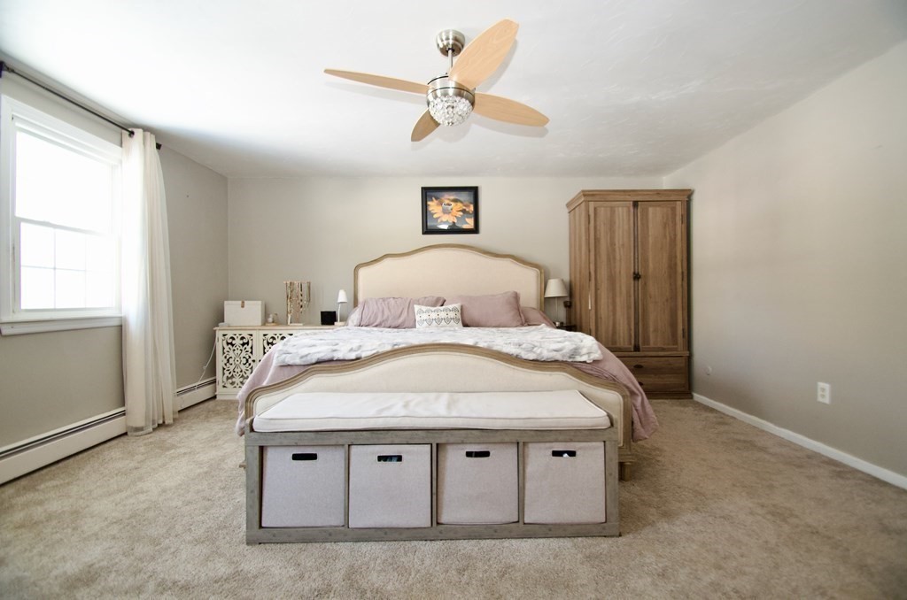 192 Mason Road Northbridge, MA 01588 - Photo 14 of 37 a spacious bedroom with a bed and a ceiling fan