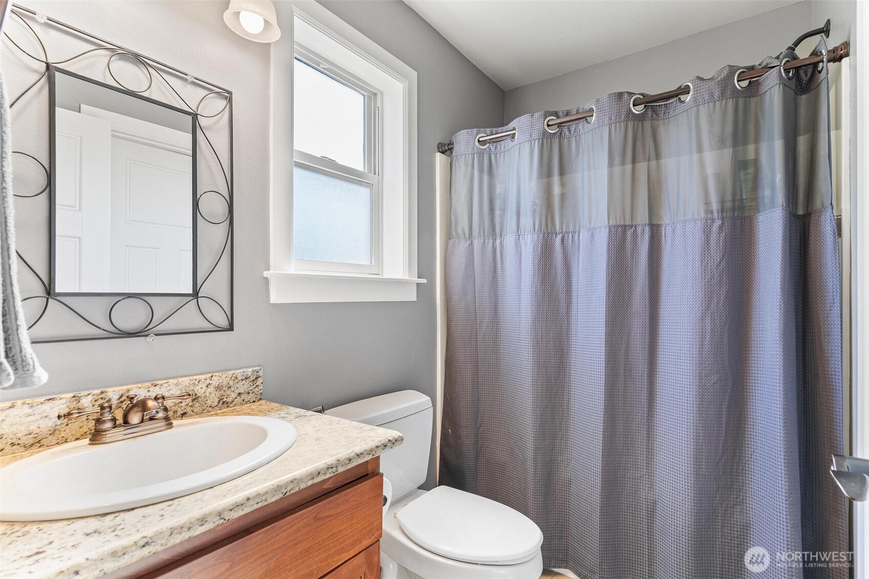 6743 Southeast 2nd Street Renton, WA 98059 - Photo 27 of 35 a bathroom with a sink vanity mirror and toilet