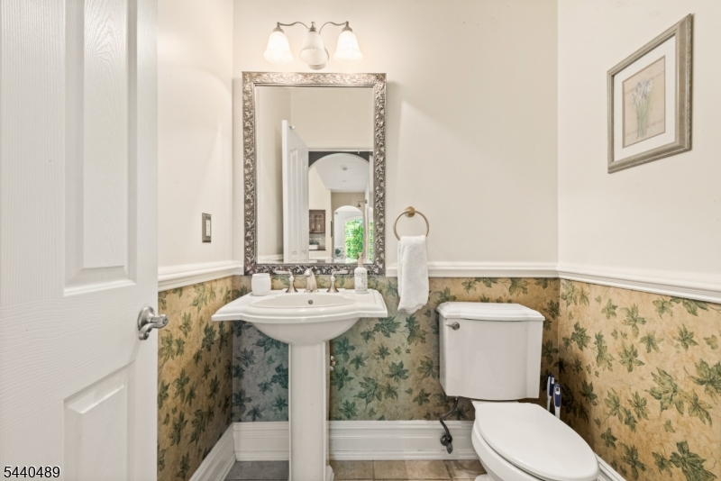 99 East Lindsley Road Cedar Grove, NJ 07009 - Photo 20 of 41 a bathroom with a toilet sink and mirror