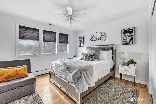 a bedroom with a large bed and a couch