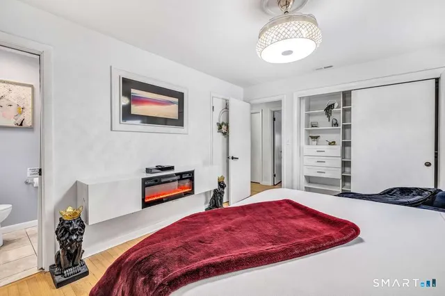 a bedroom with a bed and a chandelier