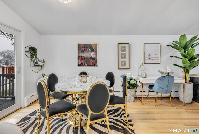 a living room with furniture a rug and a potted plant