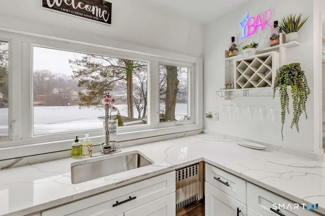 a kitchen with a sink and large window