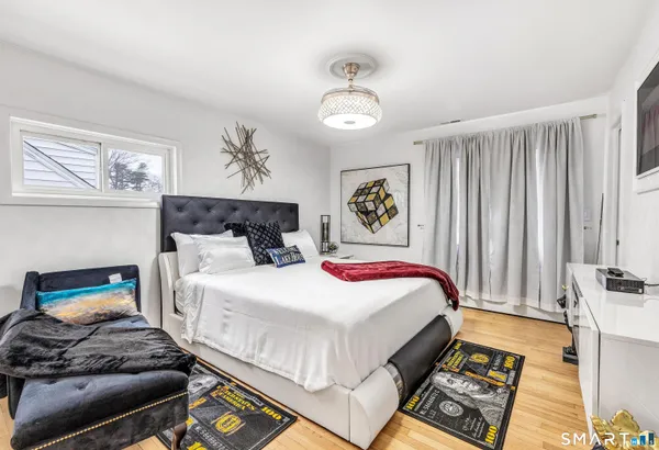 a bedroom with a bed and a chandelier