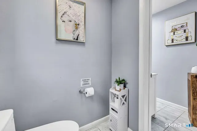 a white toilet sitting next to a bathroom sink