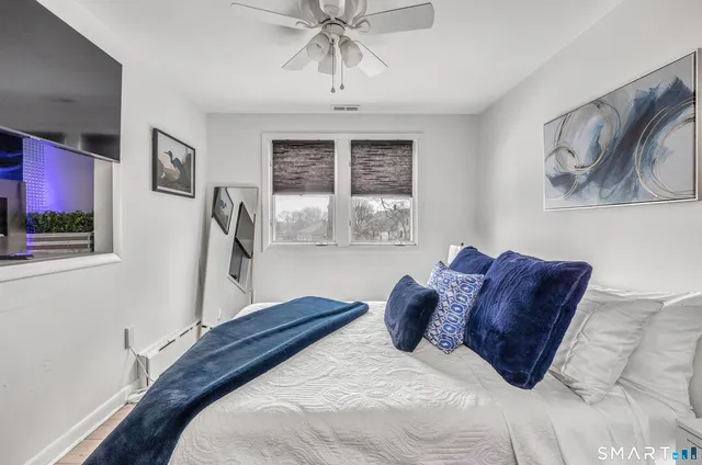 a bedroom with a bed and a window