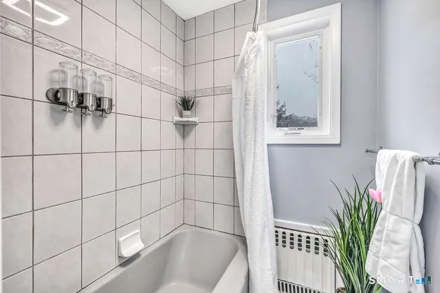 a bathroom with a bathtub and shower