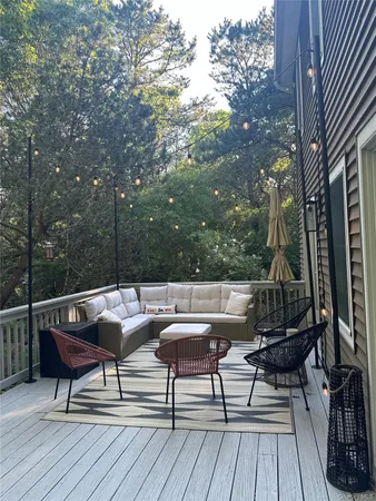 a view of a roof deck with couches and potted plants