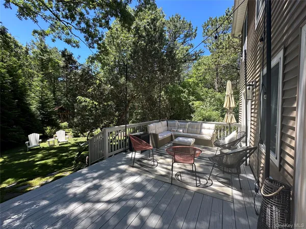 a view of a patio with table and chairs and potted plants