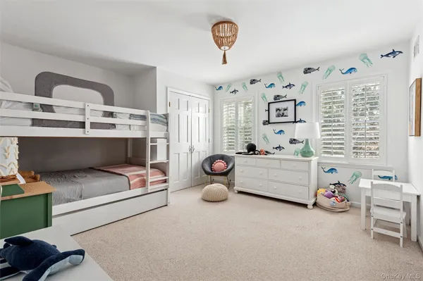 a bedroom with furniture and a window
