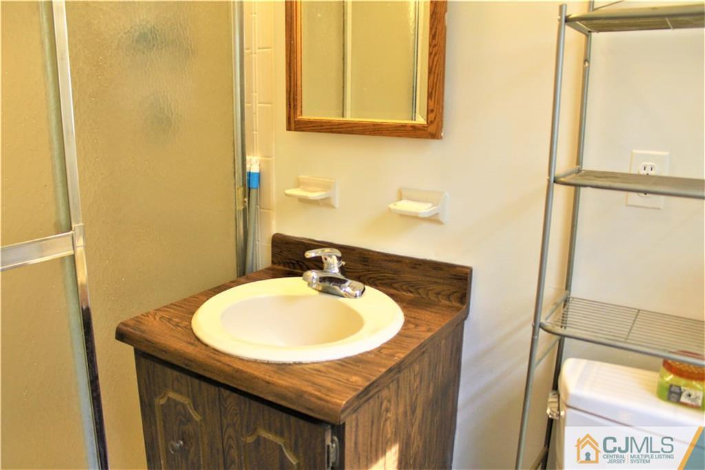 205 Normandy Road Edison, NJ 08820 - Photo 14 of 25 a bathroom with a sink and a mirror