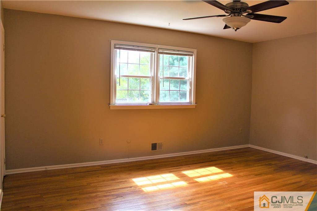 205 Normandy Road Edison, NJ 08820 - Photo 17 of 25 a view of a room with wooden floor and a window