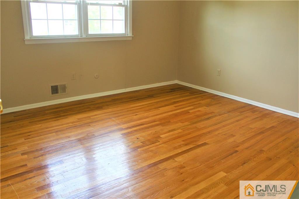 205 Normandy Road Edison, NJ 08820 - Photo 20 of 25 a view of empty room with wooden floor and fan