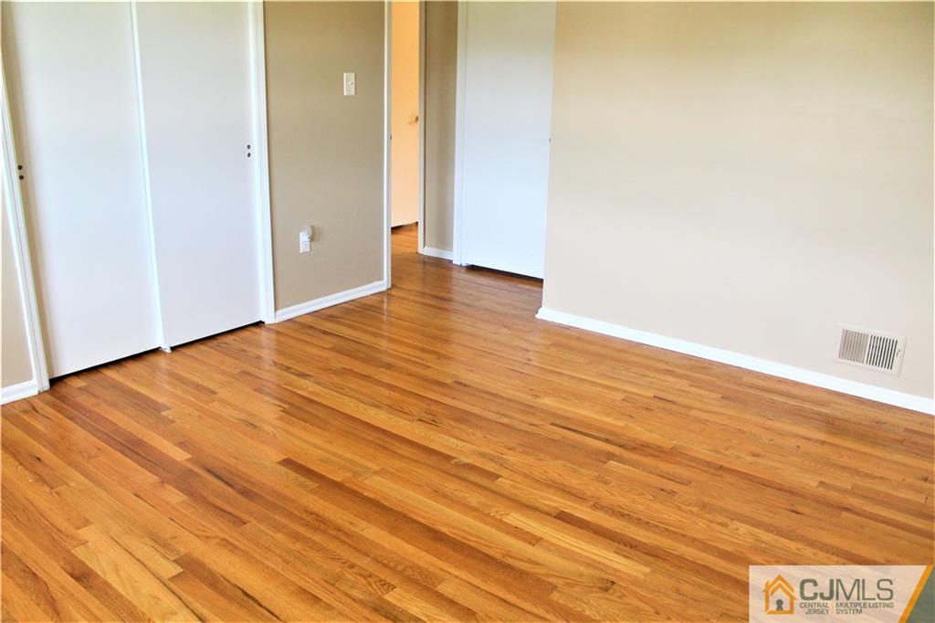205 Normandy Road Edison, NJ 08820 - Photo 22 of 25 a view of an empty room with wooden floor