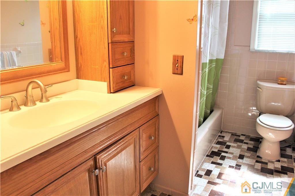 205 Normandy Road Edison, NJ 08820 - Photo 23 of 25 a bathroom with a sink a toilet and a mirror