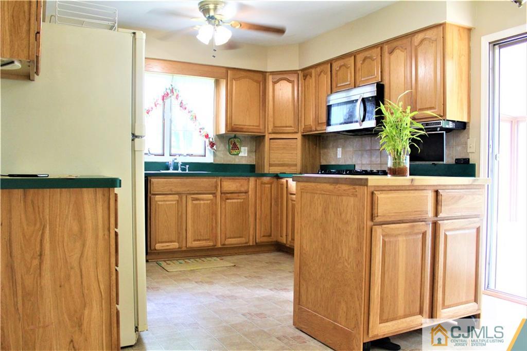 205 Normandy Road Edison, NJ 08820 - Photo 8 of 25 a kitchen with stainless steel appliances granite countertop a refrigerator and a stove