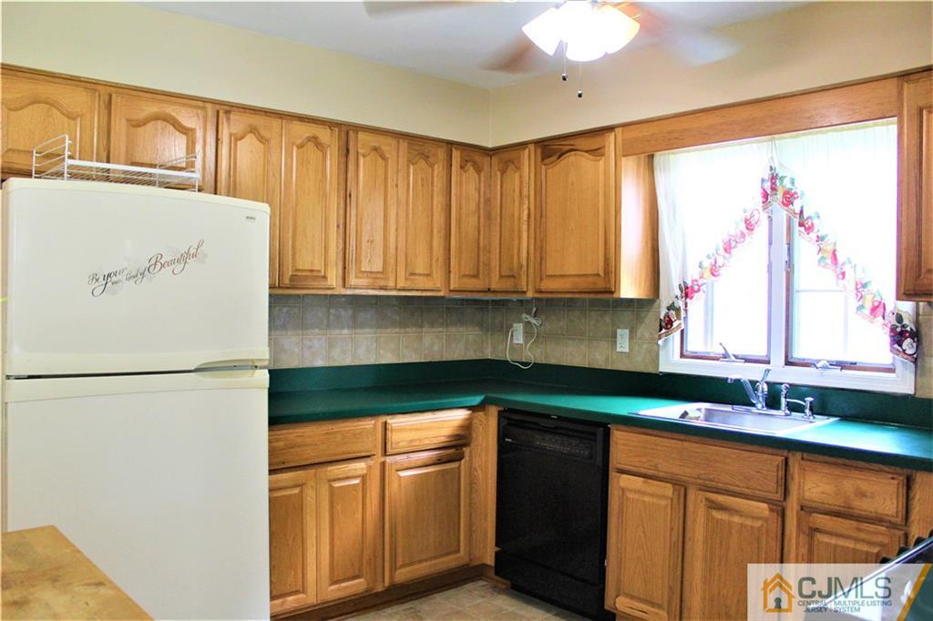 205 Normandy Road Edison, NJ 08820 - Photo 10 of 25 a utility room with stainless steel appliances granite countertop a refrigerator and a sink